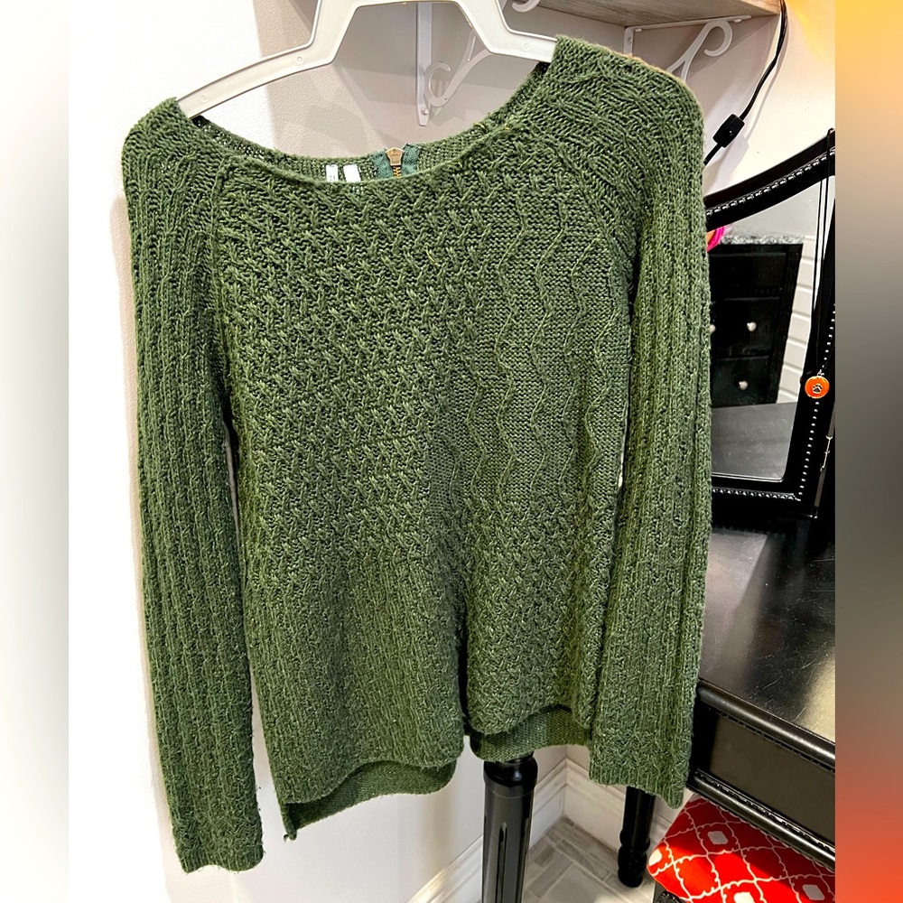 Green sweater. Gold metallic within. Zipper on back.